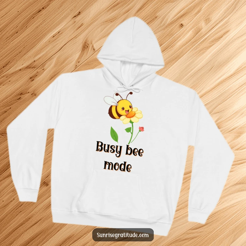 Funny playful bee hoodie, buzzing happily towards a blooming flower, providing cozy comfort and cheerful energy. A humorous and warm item.